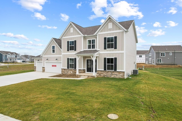 view of front of property with a garage, a front lawn, and central air condition unit