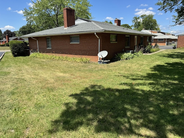 1763-1769 Ardleigh Rd Unit 1763-1769, Upper Arlington, OH 43221 - rear view of house with a chimney, brick siding, and a lawn