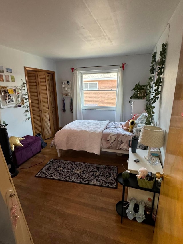 bedroom with a closet and hardwood / wood-style floors