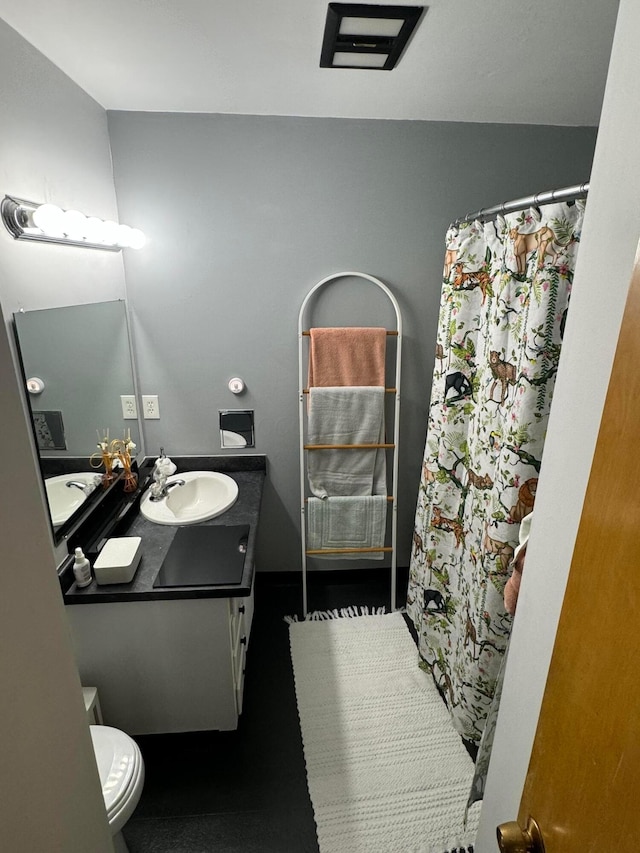 bathroom featuring vanity and toilet