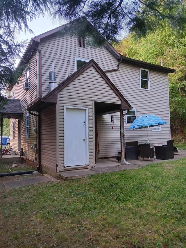 rear view of property with a patio and a yard