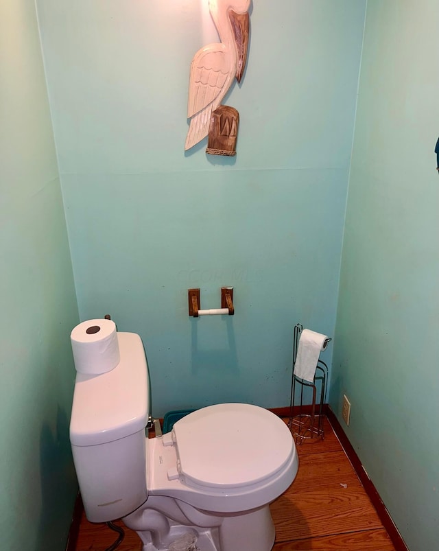 bathroom with wood-type flooring and toilet