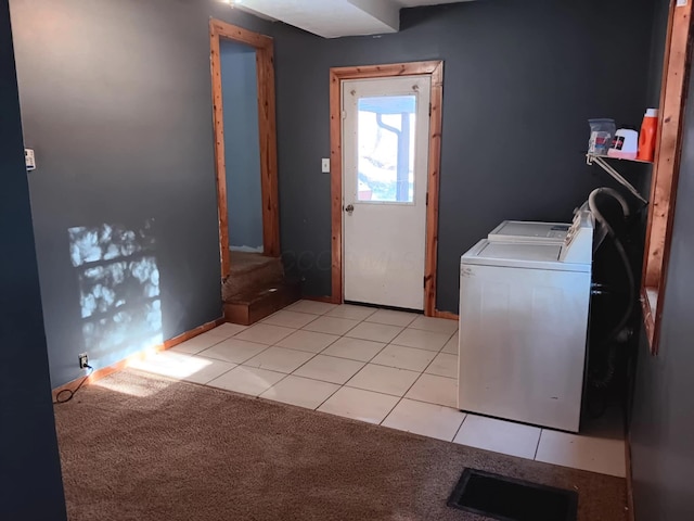 laundry area with light tile patterned floors and washing machine and dryer