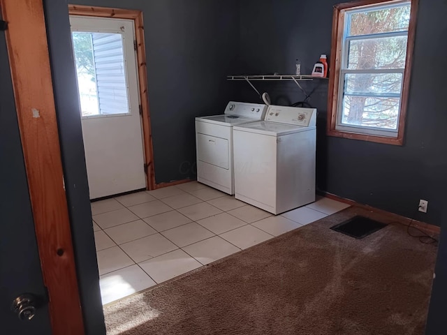 washroom with light tile patterned flooring and washing machine and dryer