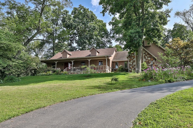 view of front of property with covered porch and a front lawn