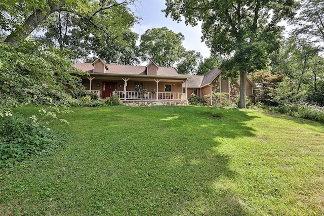 rear view of house featuring a lawn and covered porch