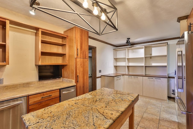 kitchen featuring light stone counters, crown molding, stainless steel appliances, and a textured ceiling