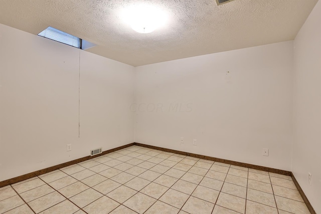 unfurnished room with a textured ceiling