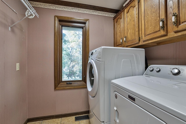 laundry room with cabinets and washer and dryer