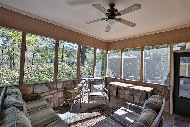 sunroom featuring ceiling fan and a wealth of natural light