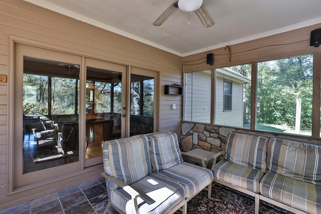 sunroom with ceiling fan and plenty of natural light