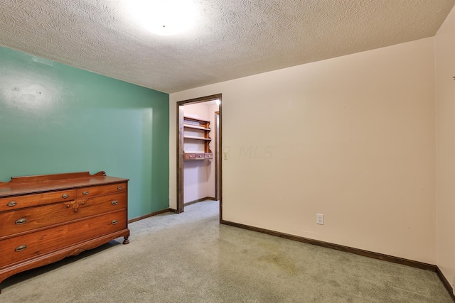 unfurnished room with a textured ceiling