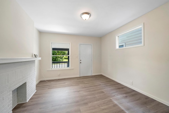 unfurnished living room featuring a fireplace and light wood-type flooring