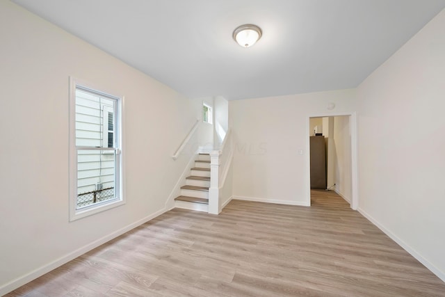 empty room with light hardwood / wood-style flooring