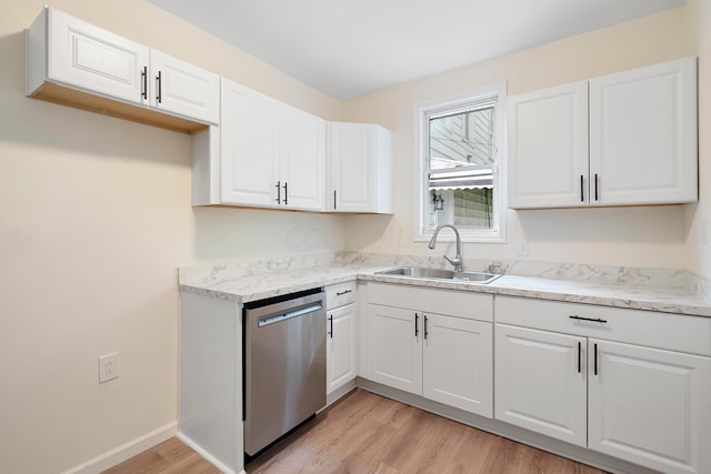 kitchen featuring white cabinetry, dishwasher, light hardwood / wood-style floors, and sink