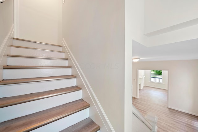 staircase featuring hardwood / wood-style flooring