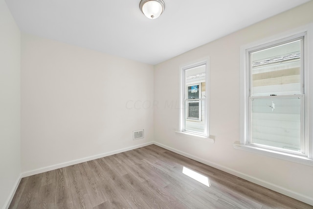 unfurnished room with light hardwood / wood-style flooring