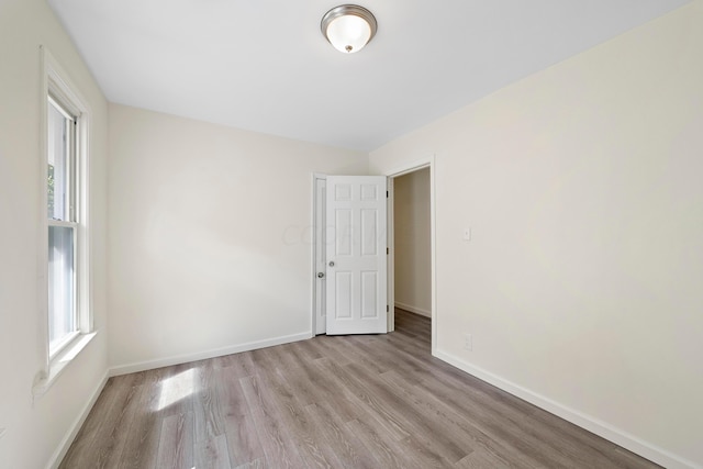 unfurnished room with light wood-type flooring