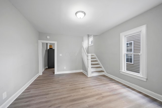 interior space with black refrigerator and light hardwood / wood-style floors