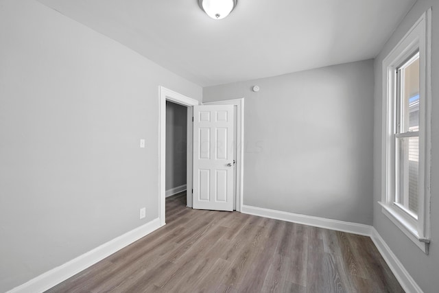 unfurnished room with light wood-type flooring