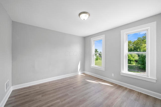 spare room with light wood-type flooring