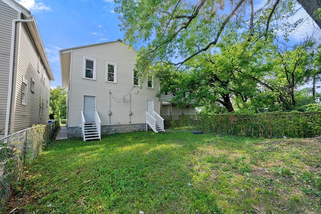 rear view of house with a lawn