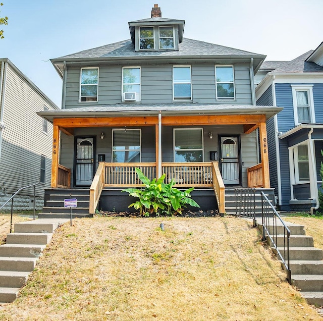 view of front of property with a porch and cooling unit