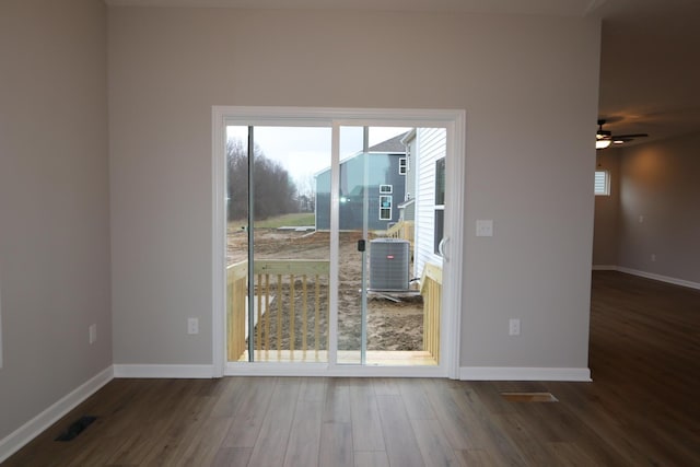 unfurnished room with ceiling fan and dark wood-type flooring