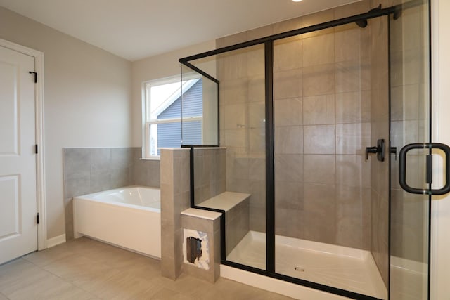 bathroom featuring tile patterned flooring and separate shower and tub