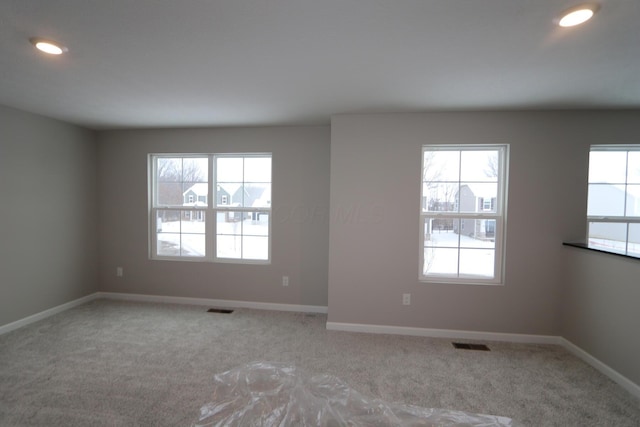 carpeted empty room with a healthy amount of sunlight