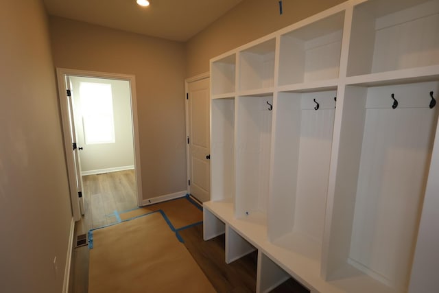 mudroom featuring recessed lighting, dark wood-style flooring, and baseboards