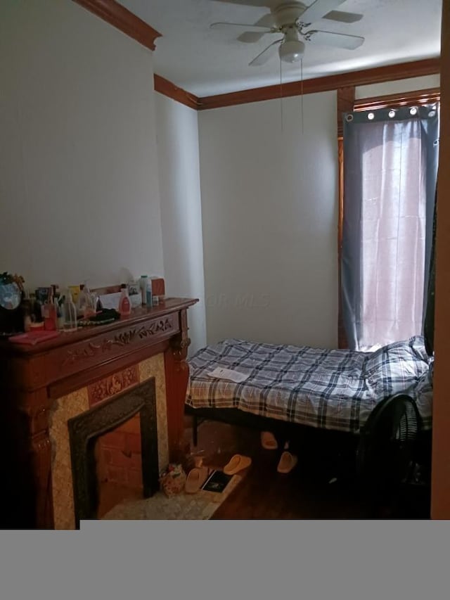 bedroom featuring ceiling fan and crown molding