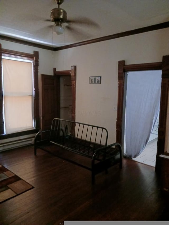 bedroom with ceiling fan, ornamental molding, and hardwood / wood-style flooring