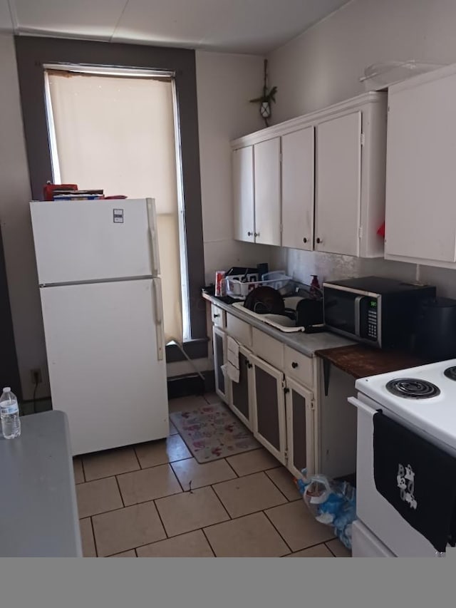 kitchen with white cabinets and white appliances