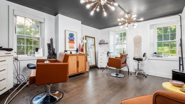 living area featuring a chandelier, dark hardwood / wood-style floors, and a healthy amount of sunlight