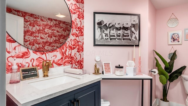 bathroom featuring vanity and toilet