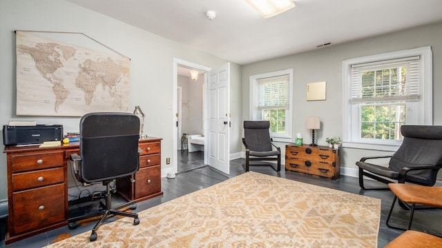 home office with dark hardwood / wood-style floors