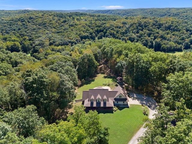 birds eye view of property featuring a view of trees