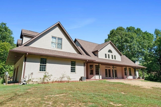 back of house with central AC, a lawn, and a patio