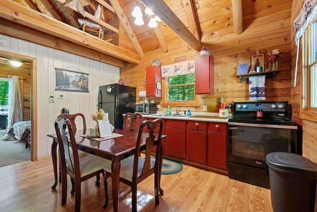 kitchen with light wood-style floors, wooden ceiling, vaulted ceiling with beams, light countertops, and black appliances