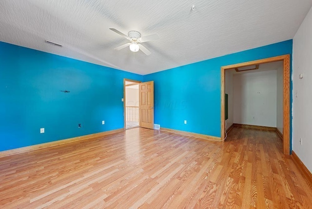 unfurnished bedroom featuring a closet, ceiling fan, light hardwood / wood-style flooring, and a textured ceiling