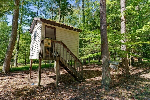 view of outbuilding featuring stairway