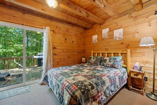 carpeted bedroom with wood walls, beam ceiling, access to exterior, and wood ceiling