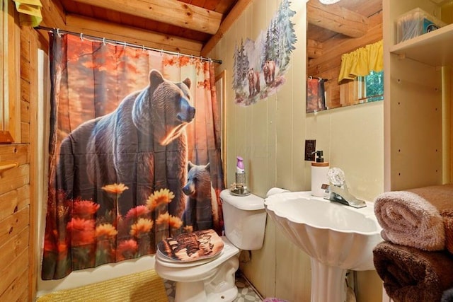 bathroom with curtained shower, wood walls, wood ceiling, and toilet