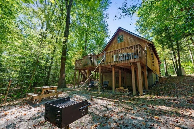 rear view of house featuring a wooden deck