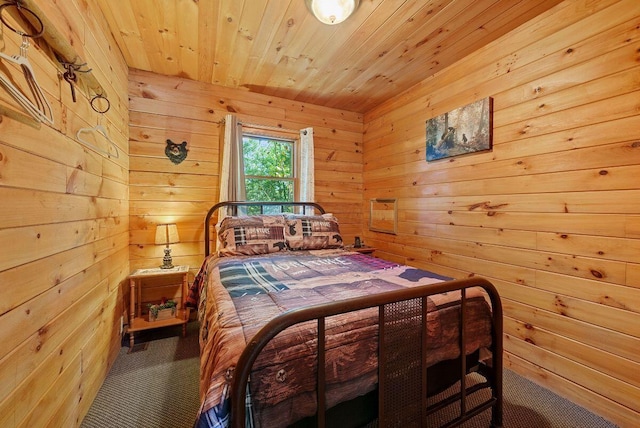 bedroom featuring wooden walls, carpet, and wooden ceiling