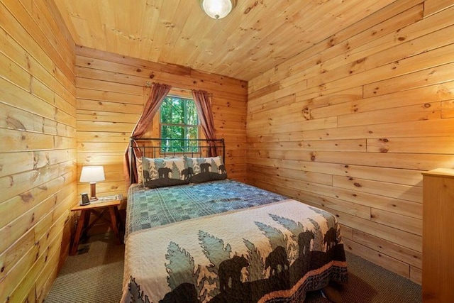 bedroom with carpet floors, wood walls, and wooden ceiling