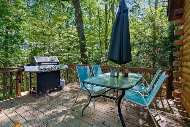 deck featuring outdoor dining area and grilling area