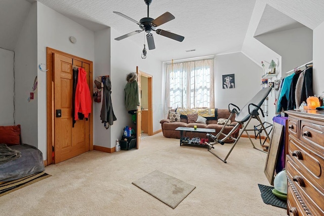 bedroom with lofted ceiling, a ceiling fan, light carpet, a textured ceiling, and baseboards