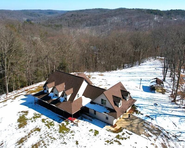 snowy aerial view featuring a view of trees